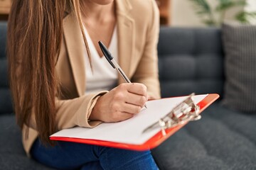 Canvas Print - Young blonde woman psychologist writing on document at street