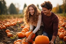 Happy Young Couple In Pumpkin Patch Field