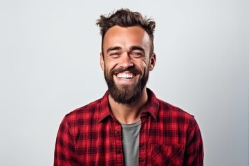 Sticker - Portrait of a happy young man laughing isolated on a white background