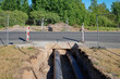 Construction of a new heating main under the road..Installing the pipe by drilling under the highway. The pipe is drilled with a strobe. Modern complex pipe laying.