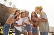 © Prostock-studio - Glad millennial arab man show smartphone to friends, people student, recommends website, app