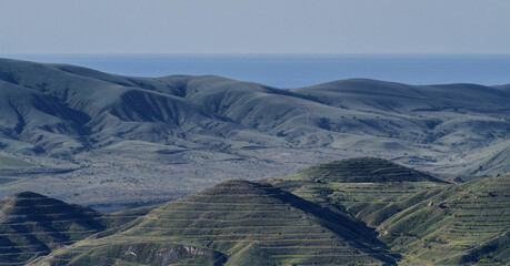 Sticker - Mounds in the form of pyramids on the background of mountain scenery