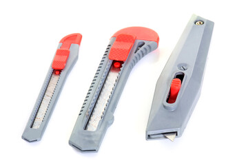 three box cutters in front of white background