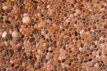 Beige warm colors polished pebble stone seamless wall decoration texture. Sea floor gravel pebble stone wall decoration