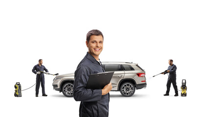 Canvas Print - Car wash manager and workers washing a SUV with a pressure washer machines