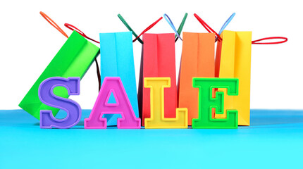 Poster - Sale written by colorful letters on the background of shopping bags