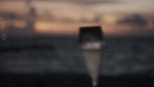 A Sparkling Wine Glass Against The Maldivian Sunset