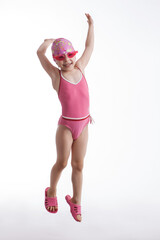 Little girl jumping in a pink swimsuit