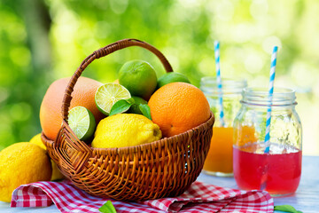 Sticker - Mix of fresh citrus fruits in basket and juice. Refreshing summer drink.