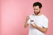 © New Africa - Handsome man with delicious yogurt and spoon on pink background. Space for text