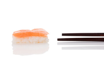 Wall Mural - Delicious luxurious nigiri sushi with salmon and chopsticks isolated on white background. Minimal contemporary asian style.