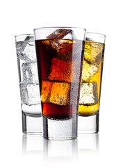 Wall Mural - Glasses of energy drink cola and  sparkling water with ice cubes and bubbles white background with reflection