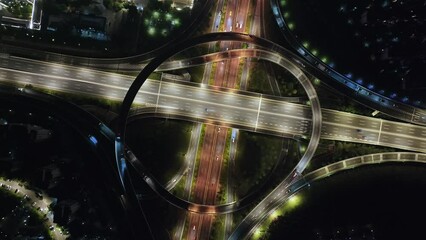 Wall Mural - View from drone of highway and overpass in modern city at night