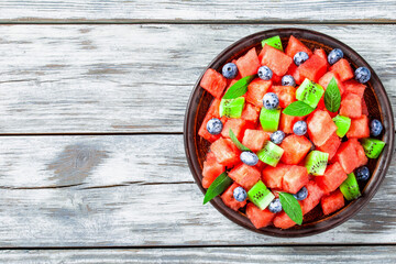 Wall Mural - Watermelon and Blueberry salad on an earthenware dish top view