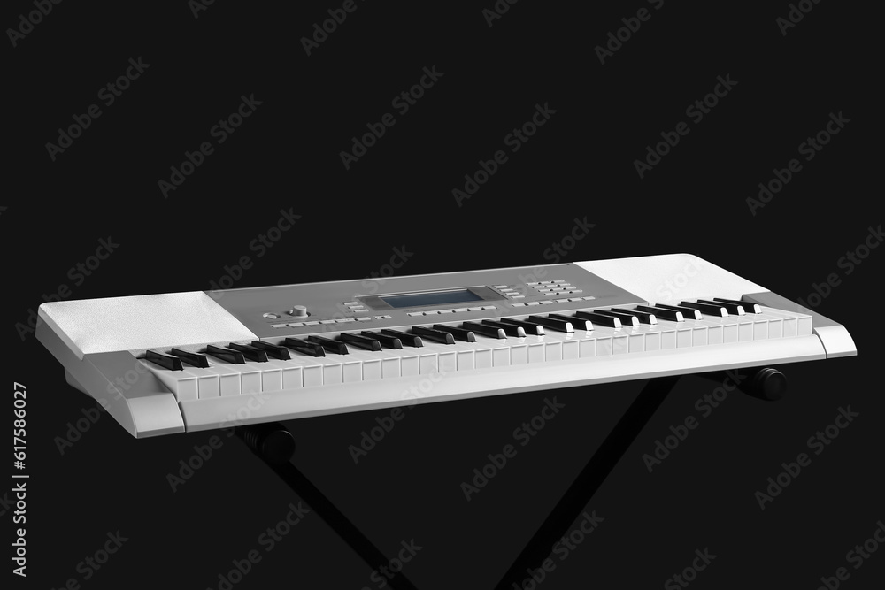 Modern synthesizer on black background