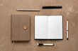 Notebooks with different school stationery on grunge brown background
