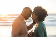 © wavebreak3 - Happy african american couple dancing and smiling on sunny beach
