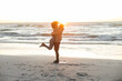 © wavebreak3 - Happy african american couple embracing on beach by sea at sunset
