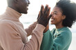 © wavebreak3 - Happy african american couple holding hands and smiling on beach