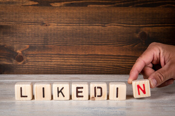 Wall Mural - linkedin word. wooden letters on a textured background.