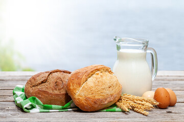 Poster - Homemade bread and milk on wooden table