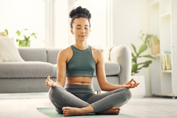 Poster - Woman, meditation and lotus pose on living room floor for peace, mental health and wellness at home. Yoga, breathing and exercise by female meditating in a lounge for zen, holistic or chakra training