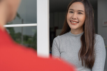 Wall Mural - Happy smiling woman receives boxes parcel from courier in front house. Delivery man send deliver express. online shopping, paper containers, takeaway, postman, delivery service, packages