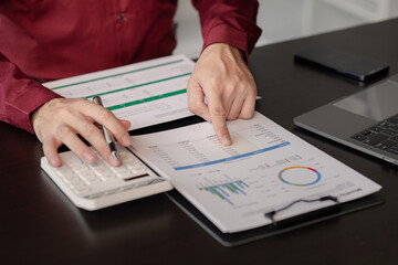 Poster - Business man pointing to a pie chart document showing company financial information, He sits in her private office, a document showing company financial information in chart form. Financial concepts.