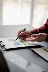 Poster - Business man pointing to a pie chart document showing company financial information, He sits in her private office, a document showing company financial information in chart form. Financial concepts.