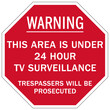 Stop no trespassing warning sign and labels this area under 24 hour tv surveillance. Trespassers wil be prosecuted