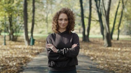 Wall Mural - Portrait of smiling ginger woman during jogging at the park. Shot with RED helium camera in 8K.