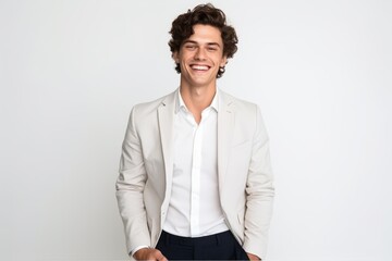 Wall Mural - Portrait of a smiling young man in suit standing isolated on a white background