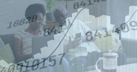 Wall Mural - Animation of changing numbers, graphs, african american couple using cellphone at home