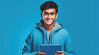 © Neuroshock - Happy indian young man using tablet created with generative AI technology