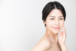 © kapinon - Japanese woman with a beautiful smile and a translucent skin, looking at the camera, copy space on the left.