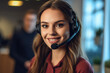 Smiling businesswoman or helpline operator with headset at call center.