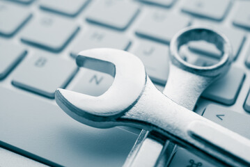 Wrench spanner on keyboard background. Customer online service center for troubleshooting quick support warranty claim concept. Computer technology product, laptop, desktop, notebook, online internet.