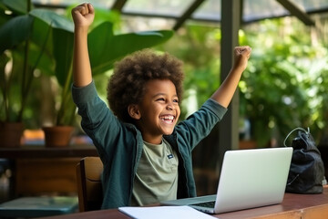 little african american school boy raising hands up with excitement during home distance education. 