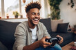 © wolfhound911 - Young positive happy african american guy with wireless gamepad playing video game at home .