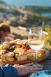 © Veronika Kovalenko - Luxury seafood board and a glass of wine with amazing sea view of Kvarner bay and Lošinj archipelago of Croatia islands