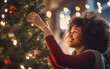 © AZ Studio - Young afro-american woman decorating Christmas tree, smiling with delight and embracing the joy of celebrating the holiday alone, during a festive day