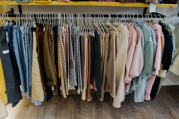 Wall Mural - Children's trousers and jeans in the store on hangers. Children's clothing store. Sale in a children's clothing store.