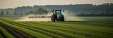 Fototapeta Zachód słońca - Tractor spraying pesticides fertilizer on soybean crops farm field in spring evening. Smart Farming Technology and Sustainable Advanced Agriculture Practices. generative ai