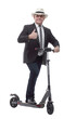 © ASDF - cheerful business man on an electric scooter giving a thumbs up