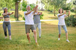 © zinkevych - A group of people practicing qigong in a park