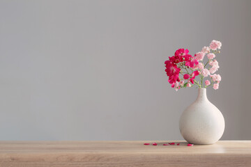 Canvas Print - pink roses in ceramic vase on wooden table