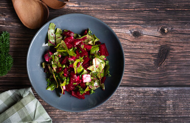 Beetroot salad with vegan feta, beetroot chard and spinach. Healthy food concept. Diet concept. Vegan diet. Shot from above.