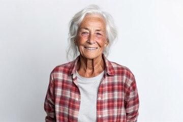 Wall Mural - Portrait of smiling senior woman looking at camera on white background.