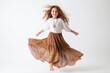 Full length portrait of a happy little girl jumping isolated on a white background
