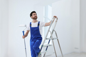 Poster - Handyman with roller on step ladder in room. Ceiling painting